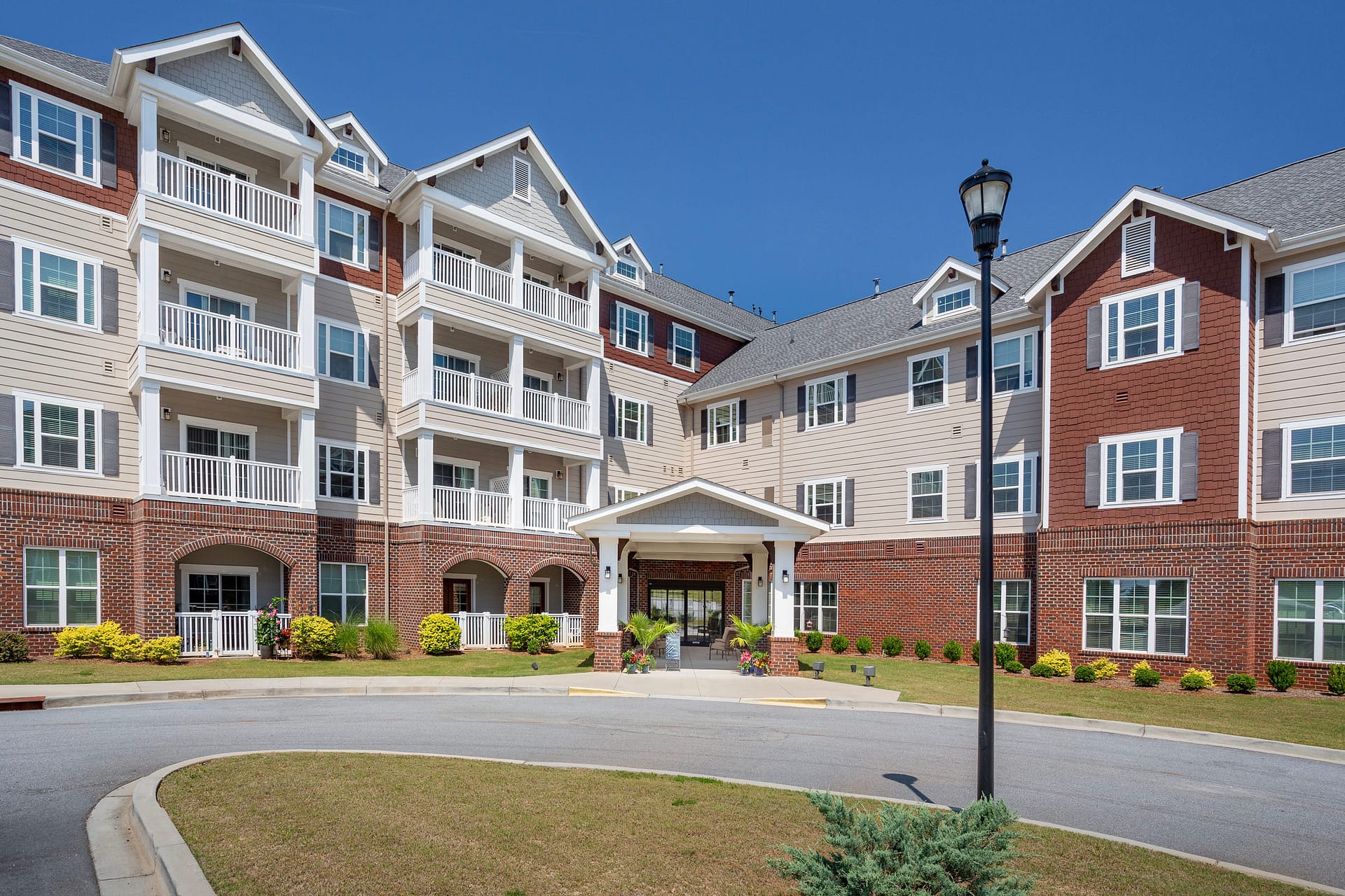 Four-story apartment building with balconies and brick facade