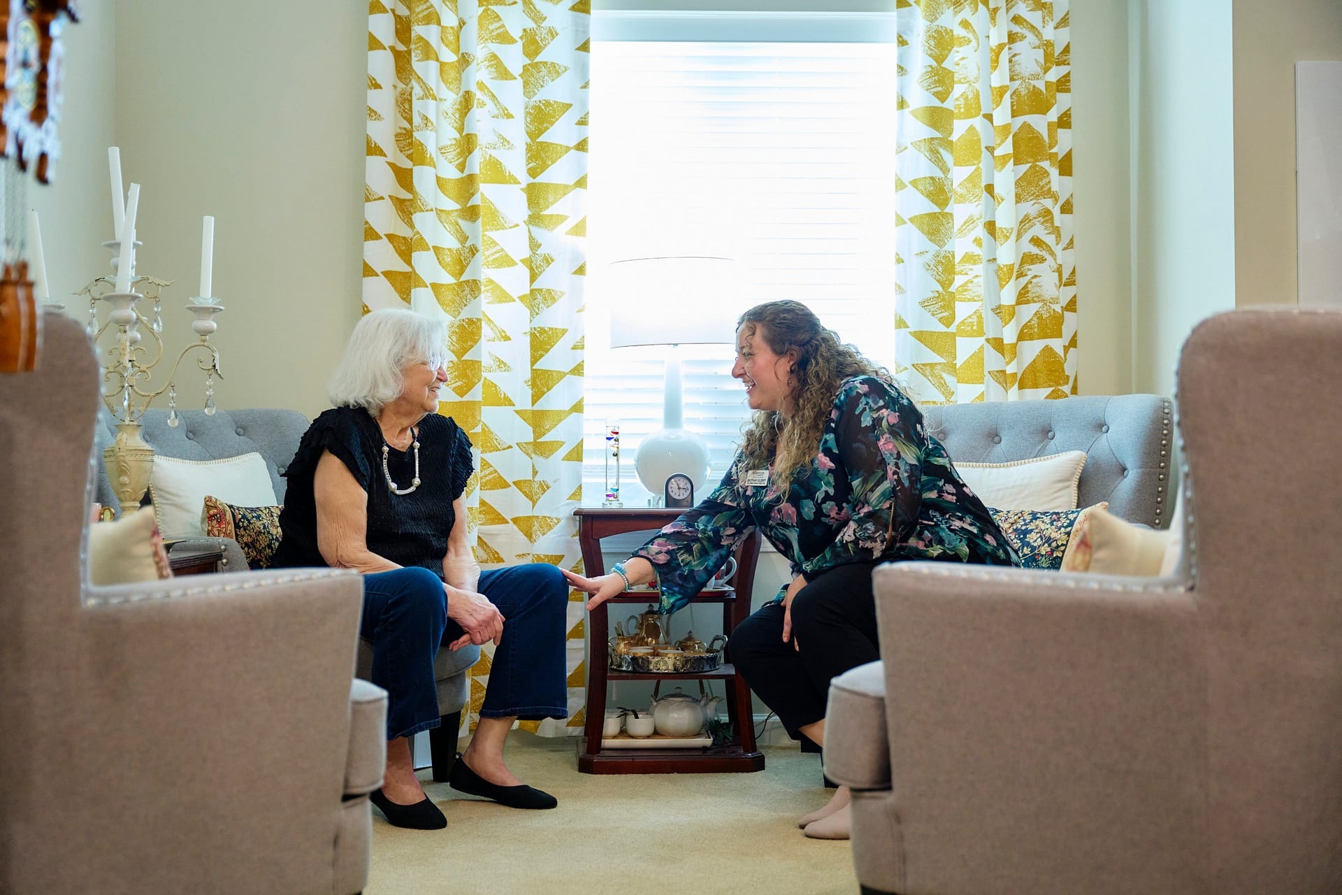 Two women talking in cozy living room