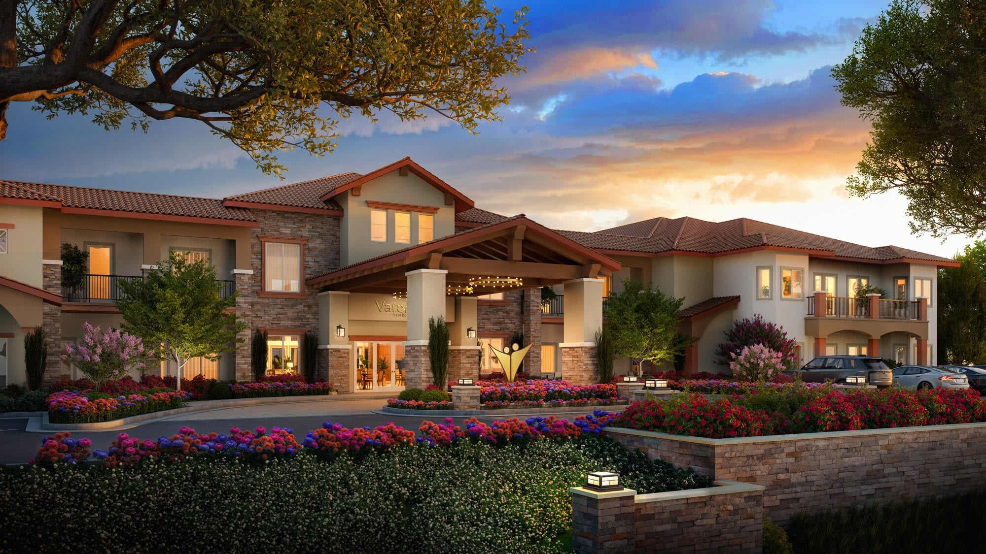 Luxury residential community entrance at sunset with landscaping