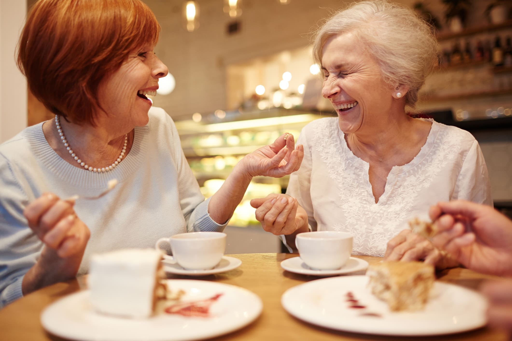 Residents laughing over teat at Brightwater Senior Living