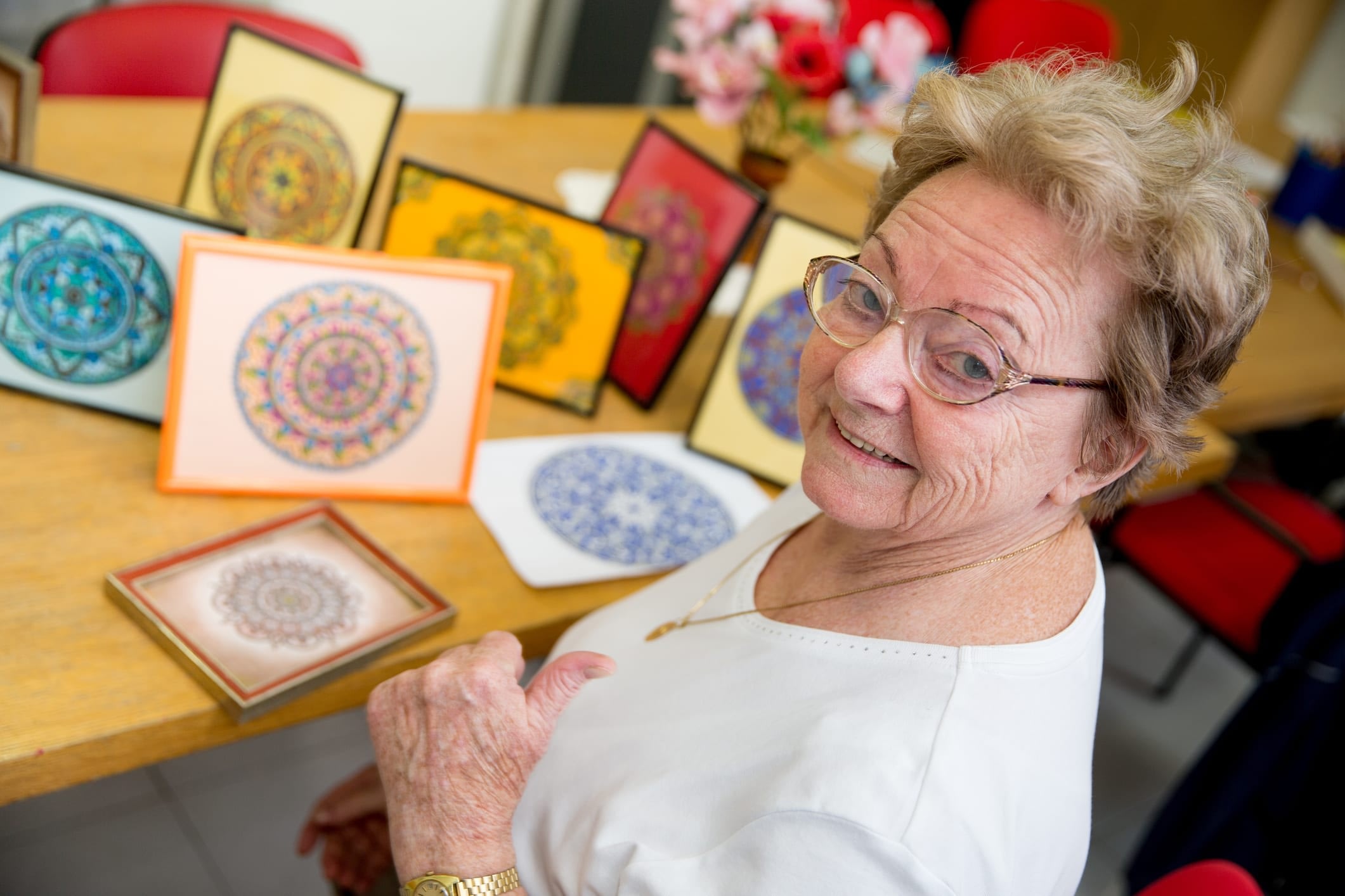Senior woman showing off arts and crafts