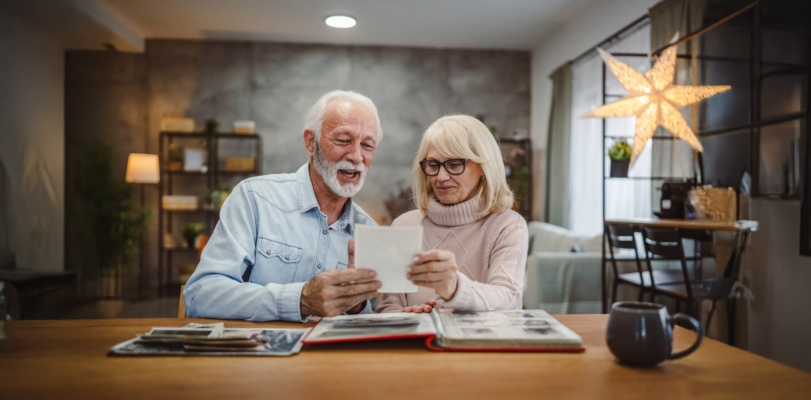 Elderly couple looking at photos together at home