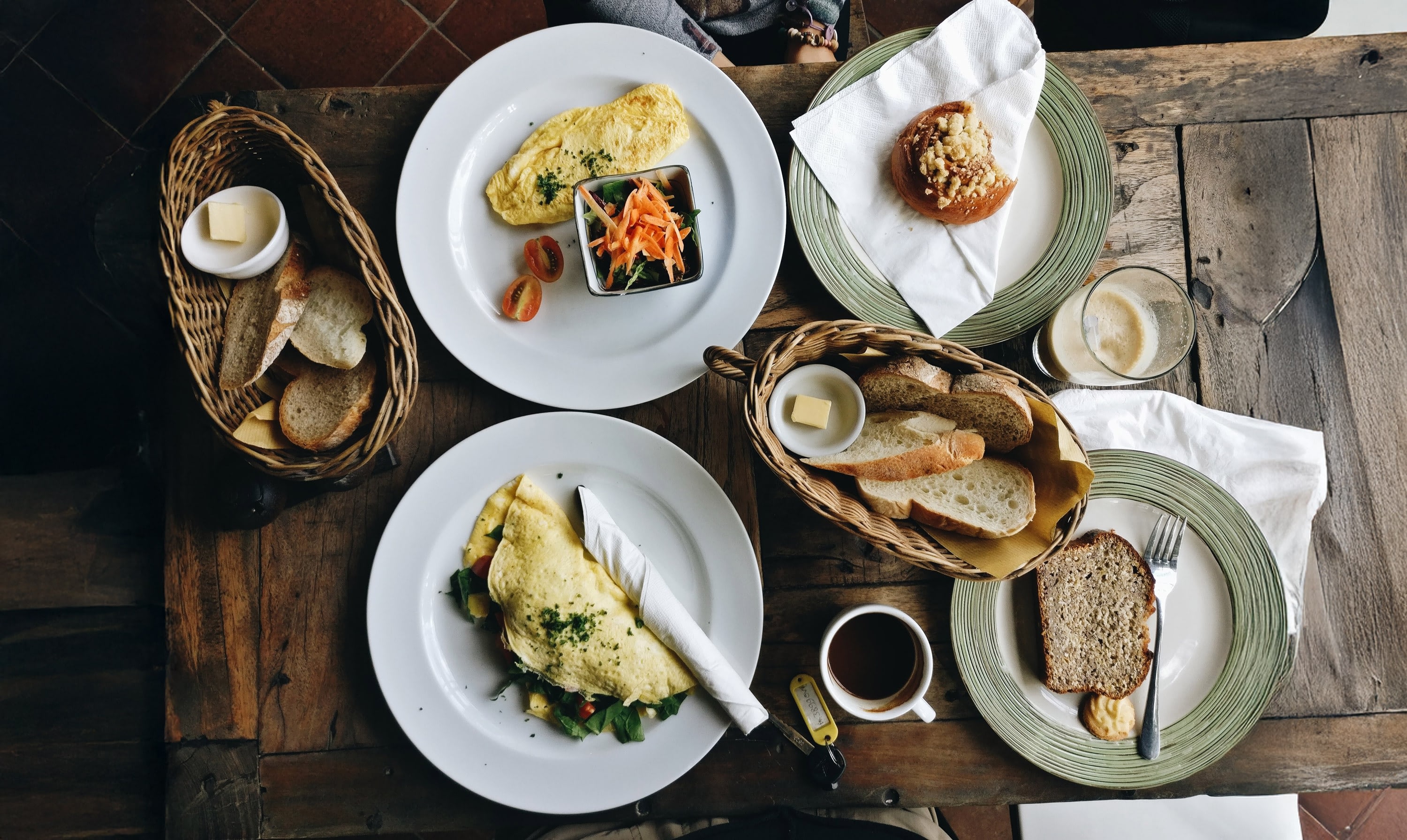 Overhead view of breakfast table with omelets and bread