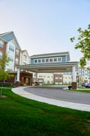Modern apartment complex with covered entrance driveway