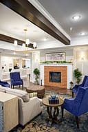 Cozy lobby seating area with brick fireplace