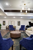 Elegant lounge with blue chairs and chandelier