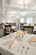 Elegant dining room with set tables and chandeliers