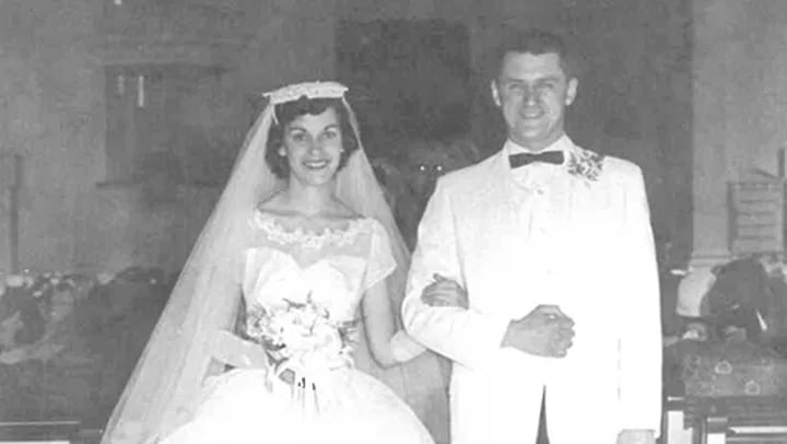 Black and white wedding photo of bride and groom
