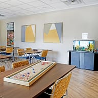 Recreation room with shuffleboard table and aquarium